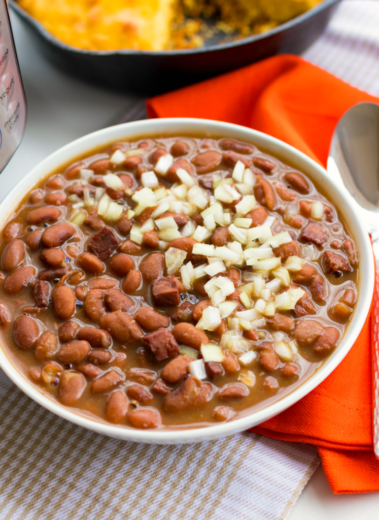 Instant Pot Pinto Beans are so easy to make! Seasoned with ham, onion and garlic then cooked in vegetable stock, this no-soak recipe is great as a main or side dish.