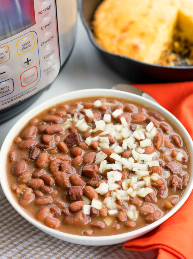 Instant Pot Pinto Beans are so easy to make! Seasoned with ham, onion and garlic then cooked in vegetable stock, this no-soak recipe is great as a main or side dish.