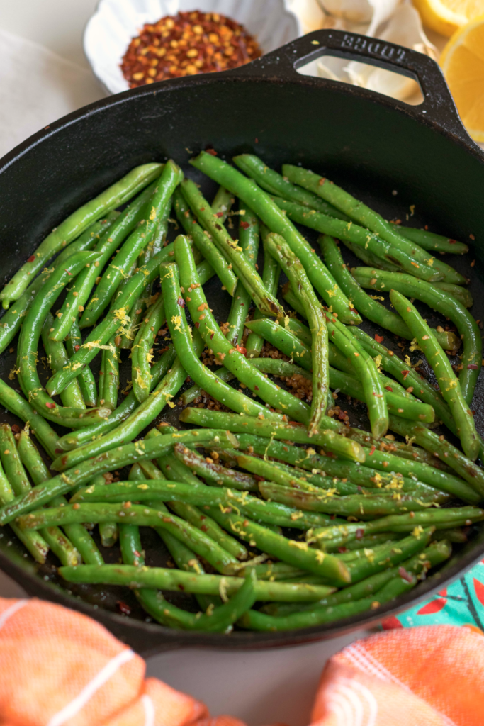 Skillet Green Beans made with garlic, lemon and red pepper is the ideal side dish for any meal! Simple and ready in 15 minutes!