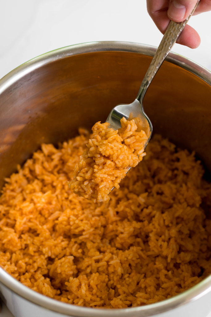 Instant Pot Mexican Rice made with white rice, tomato sauce, onions, cumin and chili powder is a great side dish for a weeknight meal or your next fiesta!
