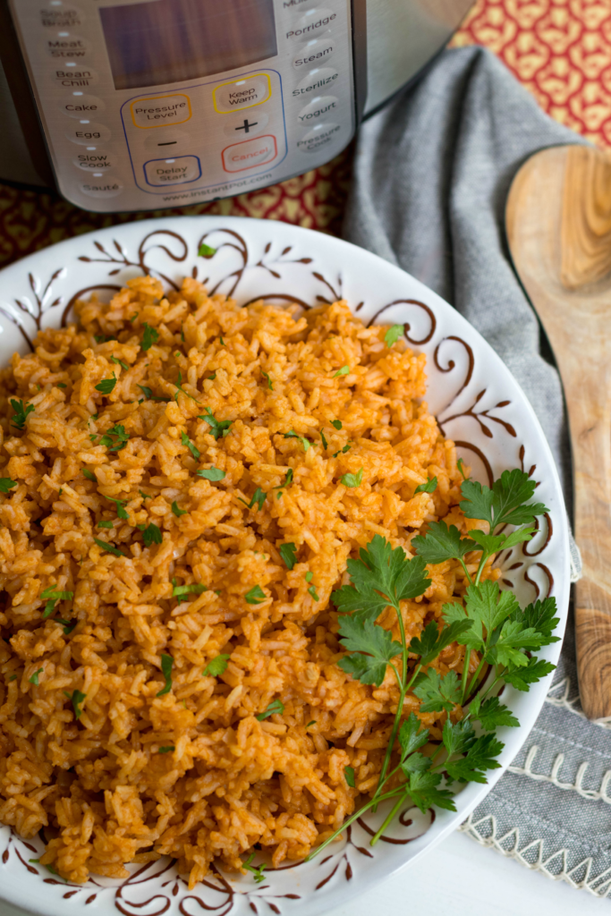 Instant Pot Mexican Rice made with white rice, tomato sauce, onions, cumin and chili powder is a great side dish for a weeknight meal or your next fiesta!