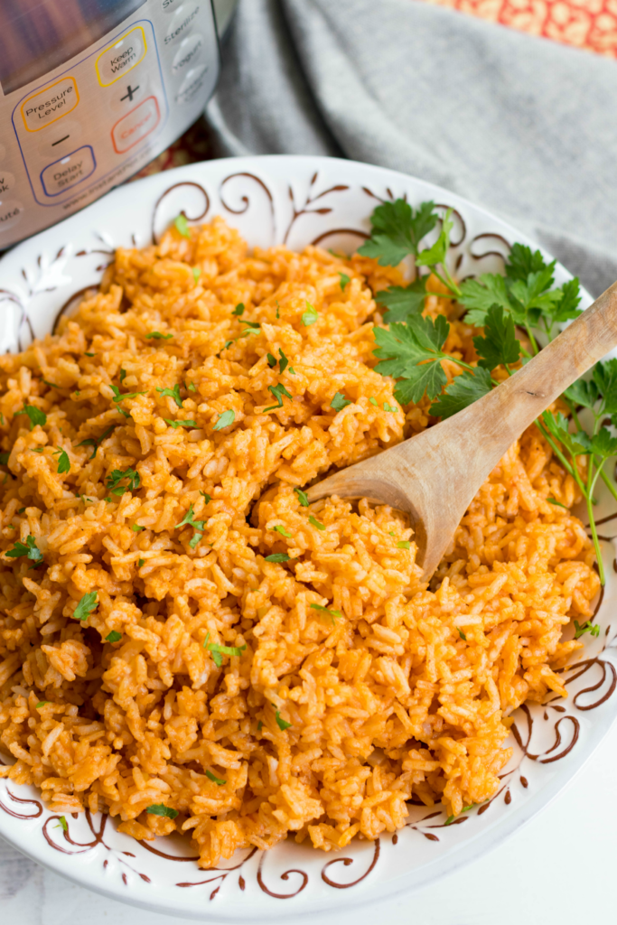 Instant Pot Mexican Rice made with white rice, tomato sauce, onions, cumin and chili powder is a great side dish for a weeknight meal or your next fiesta!