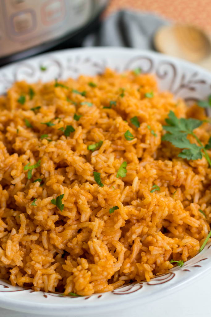 Instant Pot Mexican Rice made with white rice, tomato sauce, onions, cumin and chili powder is a great side dish for a weeknight meal or your next fiesta!