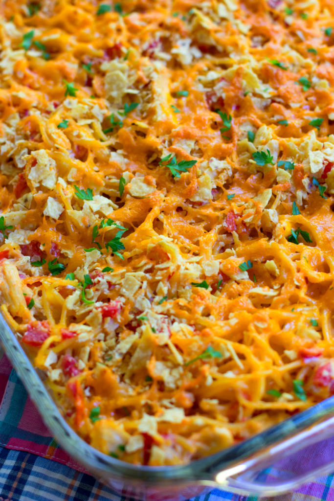 A closeup of the deliciously cheesy topping to this casserole that's made with spaghetti, chicken, Rotel tomatoes and chiles, cream cheese, sour cream and cheddar cheese.