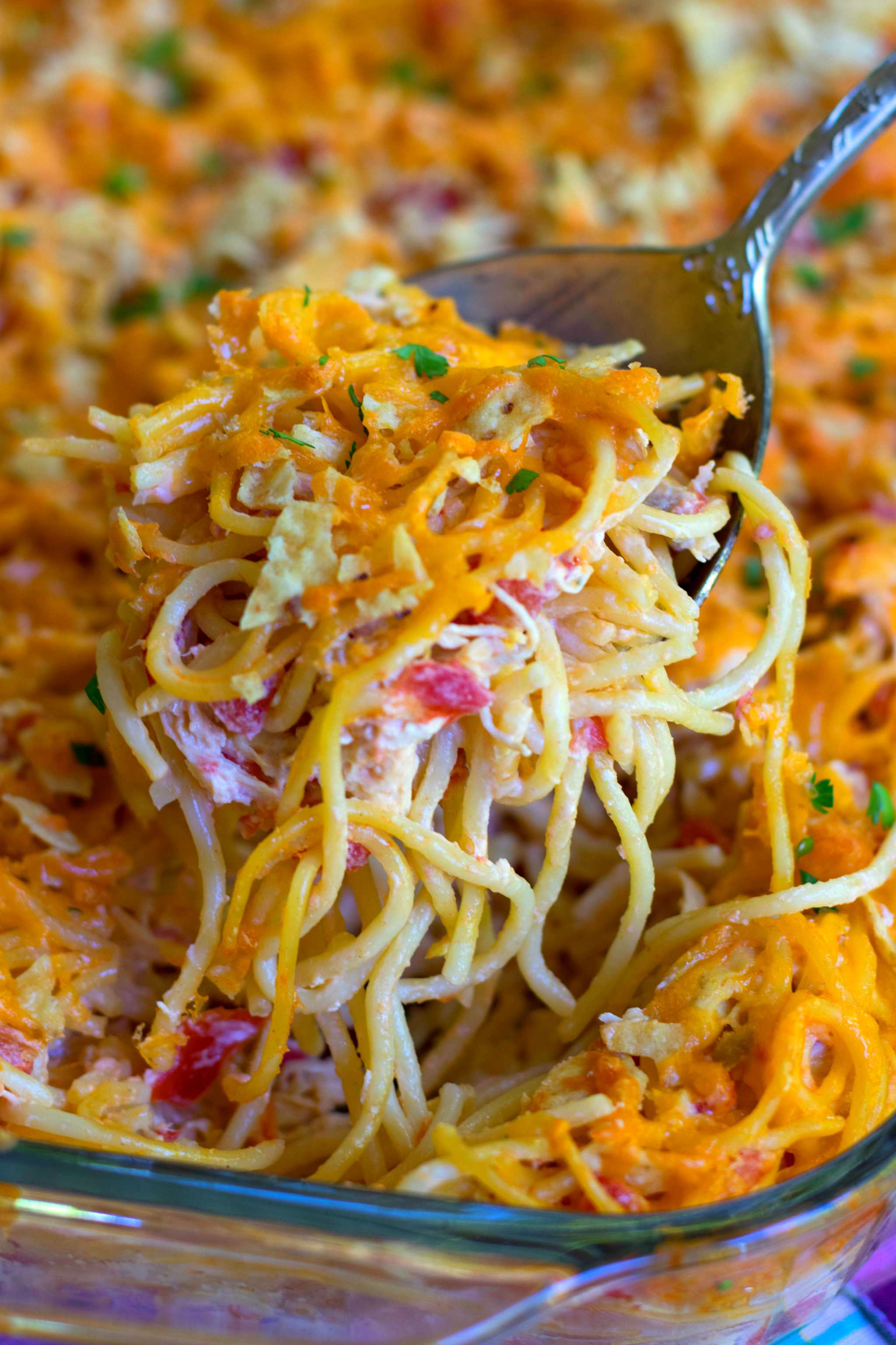 A delicious spoonful of this easy to make casserole with spaghetti, chicken, Rotel tomatoes and chiles, cream cheese, sour cream and cheddar cheese.