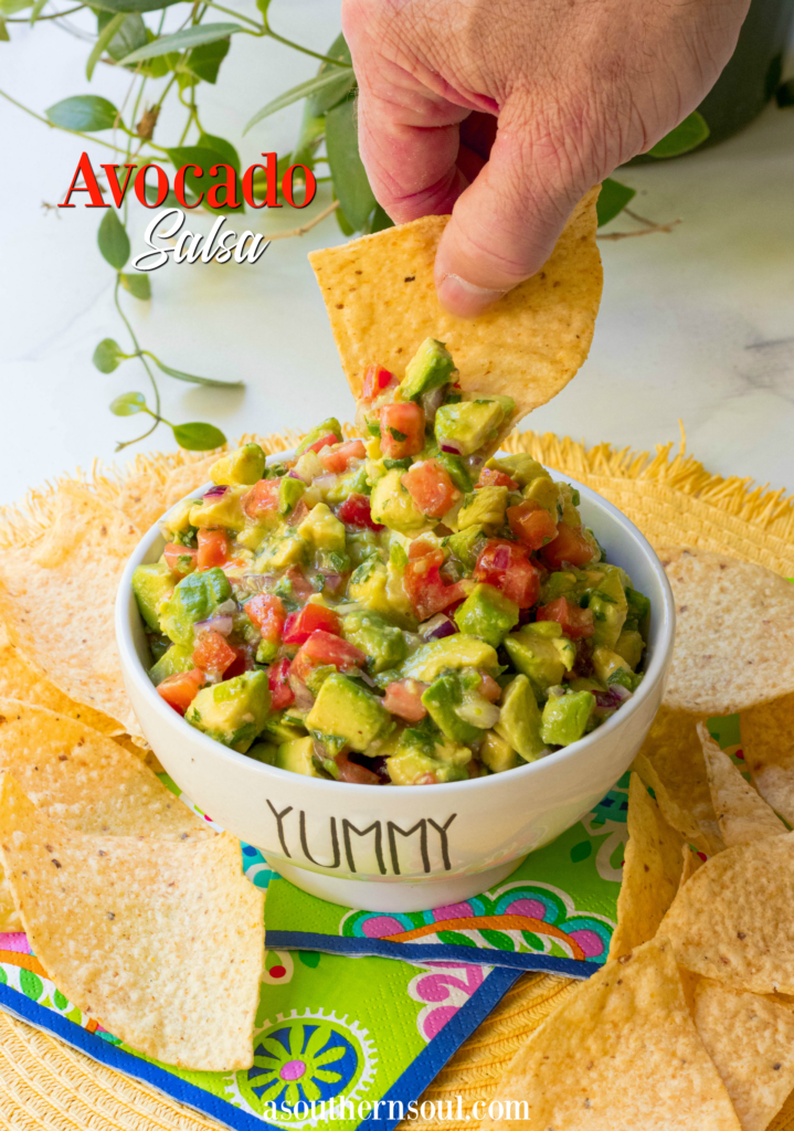 Avocado Salsa made with fresh avocado, tomatoes, jalapenos, red onion then tossed in a light dressing of lime, olive oil, garlic powder, salt and pepper. This is the perfect dip to serve at your next party and it's also delicious served with fish or chicken.