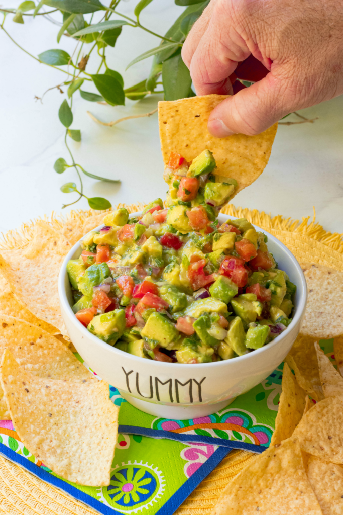 Avocado Salsa made with fresh avocado, tomatoes, jalapenos, red onion then tossed in a light dressing of lime, olive oil, garlic powder, salt and pepper. This is the perfect dip to serve at your next party and it's also delicious served with fish or chicken.
