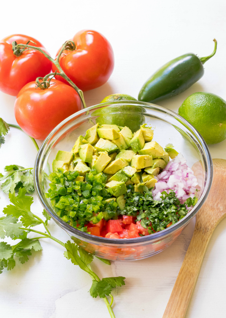 Avocado Salsa made with fresh avocado, tomatoes, jalapenos, red onion then tossed in a light dressing of lime, olive oil, garlic powder, salt and pepper. This is the perfect dip to serve at your next party and it's also delicious served with fish or chicken.