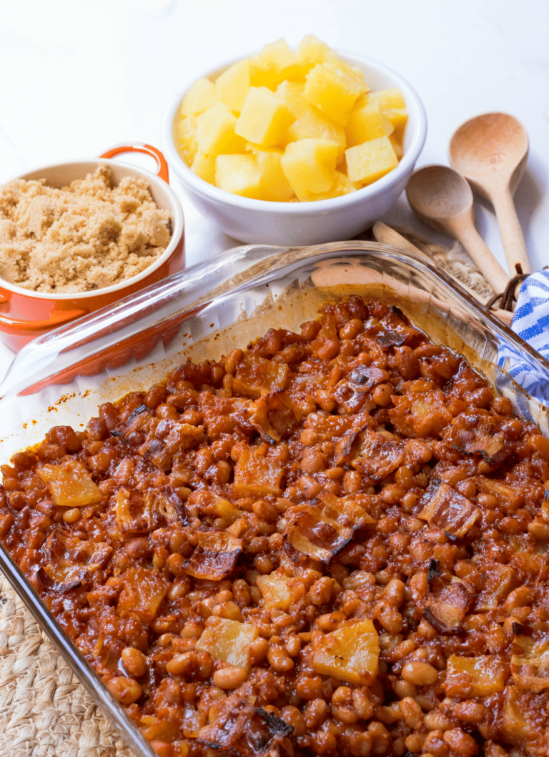 Pineapple BBQ Baked Beans made with canned beans, your favorite BBQ sauce, onion, brown sugar, whole grain mustard, pineapple chunks and bacon. They are baked to perfection and make a great side dish for any cookout, potluck, covered dish supper, and are great when you need to feed a crowd!