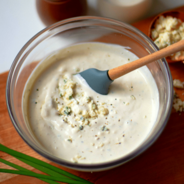 Easy Blue Cheese Dressing made with crumbled blue cheese, sour cream, mayonnaise, garlic powder, cream, chives, salt and pepper is so good! Drizzled it on lettuce for an amazing salad or serve as a dip with fresh veggies.