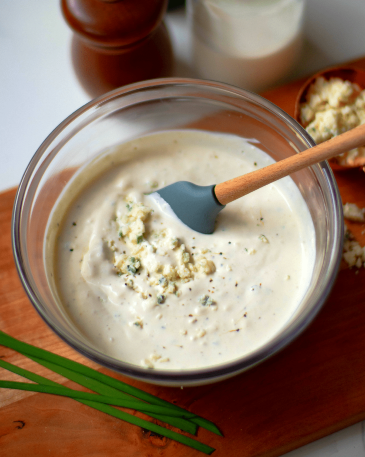 Easy Blue Cheese Dressing made with crumbled blue cheese, sour cream, mayonnaise, garlic powder, cream, chives, salt and pepper is so good! Drizzled it on lettuce for an amazing salad or serve as a dip with fresh veggies.