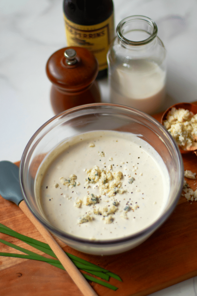 Easy Blue Cheese Dressing made with crumbled blue cheese, sour cream, mayonnaise, garlic powder, cream, chives, salt and pepper is so good! Drizzled it on lettuce for an amazing salad or serve as a dip with fresh veggies.