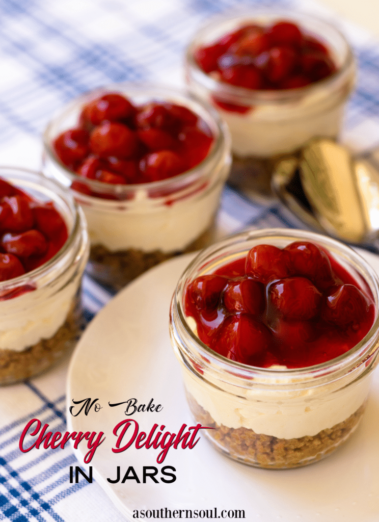 No Bake Cherry Delight In Jars is a yummy, easy to make dessert. A crust made with crushed graham crackers, butter and sugar is layered into small jars then topped with a mixture of cream cheese, powdered sugar and fresh whipped cream all topped with cherry pie filling.