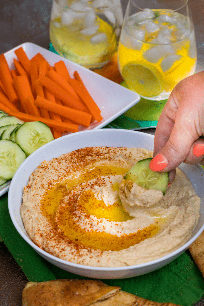 Roasted Garlic Hummus is so delicious and easy to make. Made with olive oil, roasted garlic cloves, chickpeas, lemon juice, tahini, salt and red pepper flakes that are blended together until silky smooth.