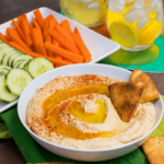 Roasted Garlic Hummus is so delicious and easy to make. Made with olive oil, roasted garlic cloves, chickpeas, lemon juice, tahini, salt and red pepper flakes that are blended together until silky smooth.