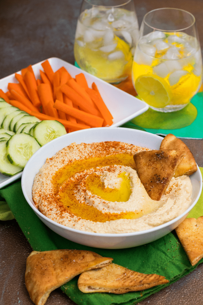 Roasted Garlic Hummus is so delicious and easy to make. Made with olive oil, roasted garlic cloves, chickpeas, lemon juice, tahini, salt and red pepper flakes that are blended together until silky smooth.