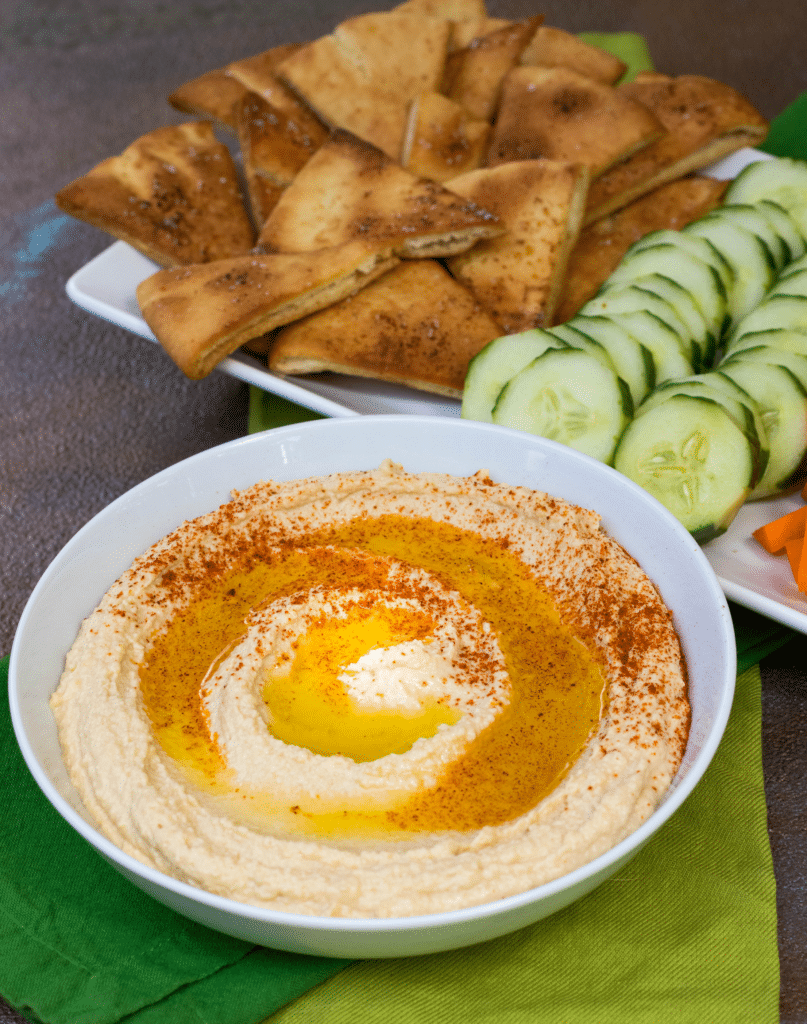 Roasted Garlic Hummus is so delicious and easy to make. Made with olive oil, roasted garlic cloves, chickpeas, lemon juice, tahini, salt and red pepper flakes that are blended together until silky smooth.