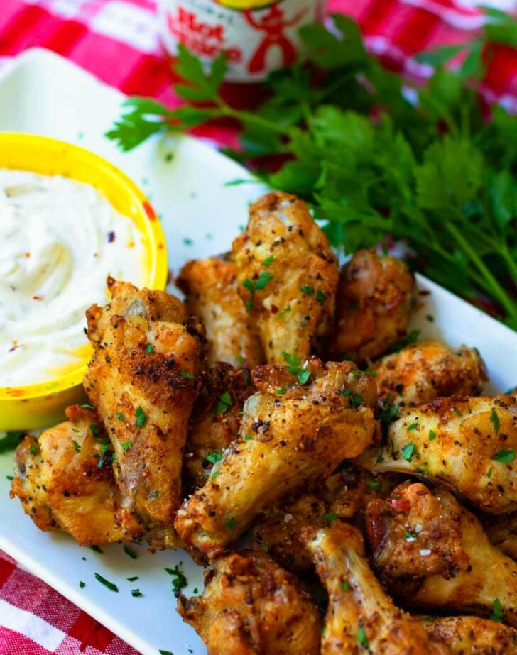 Air Fryer chicken wings are crispy, crunch and juicy. Made with chicken wings, Montreal Steak seasoning, garlic powder and salt. They are super yummy served with cool ranch dip and Texas Pete hot sauce.