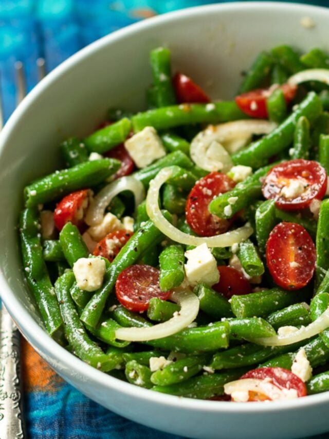 Green Bean Salad made with fresh bean, tomatoes, onions and feta cheese, tossed into a light lemony dressing is the perfect side dish for any meal!
