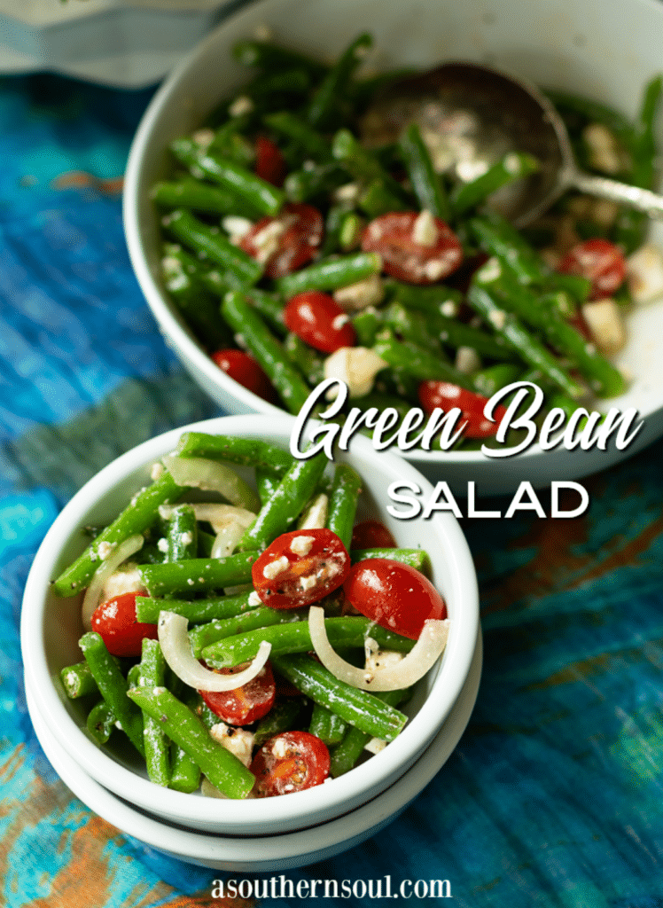Green Bean Salad made with fresh bean, tomatoes, onions and feta cheese, tossed into a light lemony dressing is the perfect side dish for any meal!