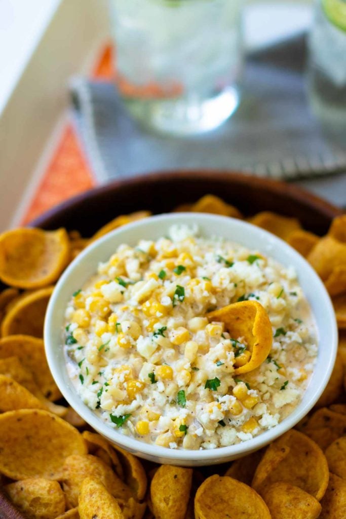 Mexican Corn Dip made with white and yellow corn, mayonnaise, sour cream, cojita cheese, canned green chilies, chicli powder, garlic, salt and cilanto. A yummy, easy to make appetizer servd with corn chips or tortillas.