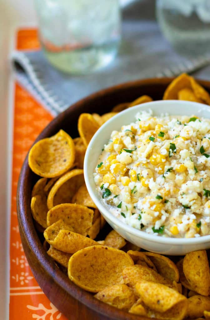 Mexican Corn Dip made with white and yellow corn, mayonnaise, sour cream, cojita cheese, canned green chilies, chicli powder, garlic, salt and cilanto. A yummy, easy to make appetizer servd with corn chips or tortillas.