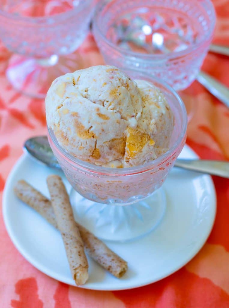 No Churn Peach Ice Cream made with fresh chopped peaches, whipped heavy cream, condensed milk, vanilla and a pinch of salt is delicious! It's sweet, creamy and no ice cream maker is required.