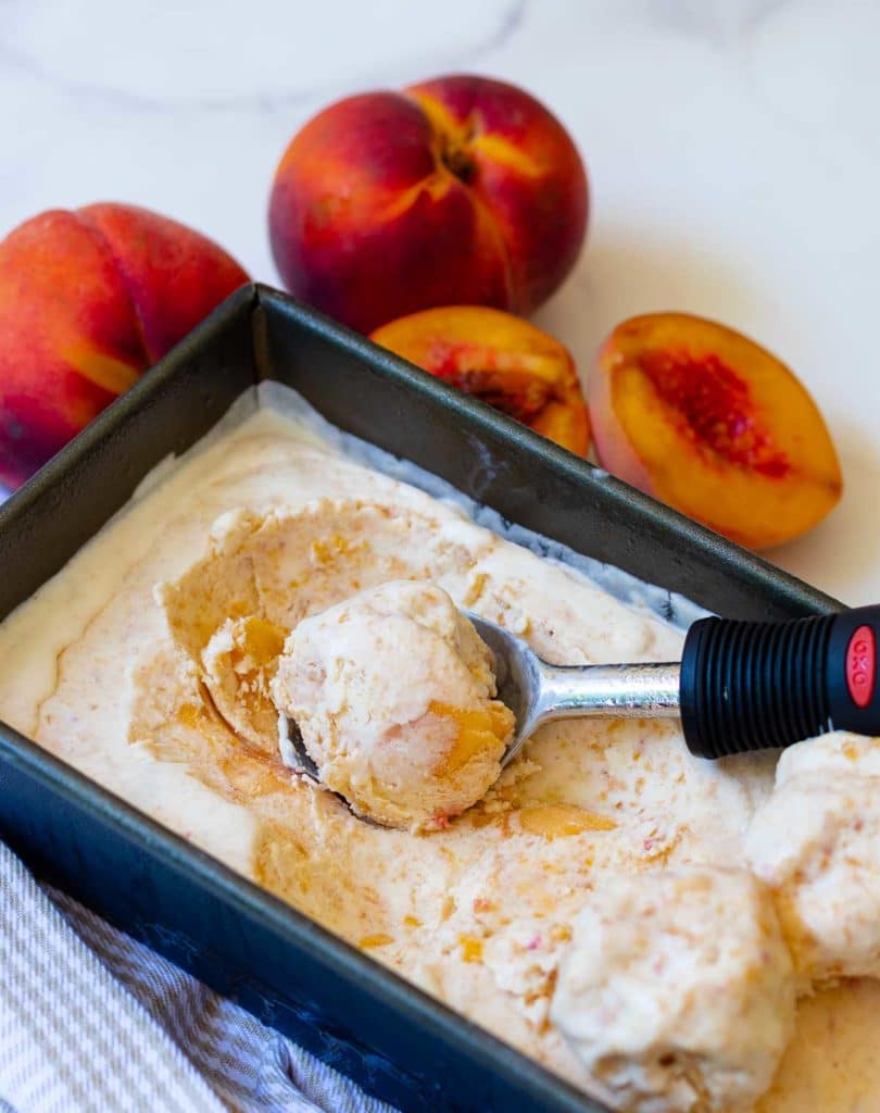 No Churn Peach Ice Cream made with fresh chopped peaches, whipped heavy cream, condensed milk, vanilla and a pinch of salt is delicious! It's sweet, creamy and no ice cream maker is required.
