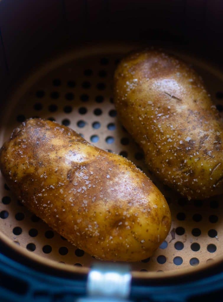 Baked Potatoes made in the Air Fryer are tender and fully on the outside with a crispy skin that makes them irresistible. Easy to make, just add your favorite toppings like butter, chives, sour cream, salt and pepper.