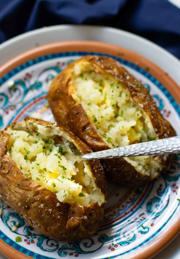 Baked Potatoes made in the Air Fryer are tender and fully on the outside with a crispy skin that makes them irresistible. Easy to make, just add your favorite toppings like butter, chives, sour cream, salt and pepper.