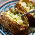 Baked Potatoes made in the Air Fryer are tender and fully on the outside with a crispy skin that makes them irresistible. Easy to make, just add your favorite toppings like butter, chives, sour cream, salt and pepper.