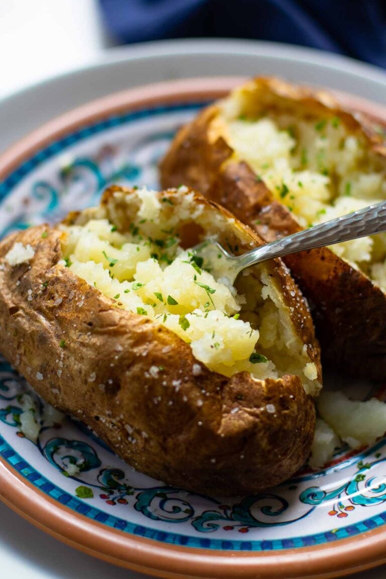 Baked Potatoes made in the Air Fryer are tender and fully on the outside with a crispy skin that makes them irresistible. Easy to make, just add your favorite toppings like butter, chives, sour cream, salt and pepper.