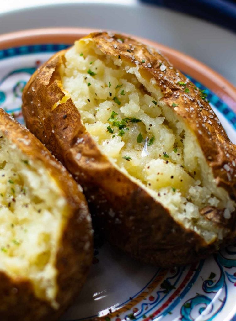 Baked Potatoes made in the Air Fryer are tender and fully on the outside with a crispy skin that makes them irresistible. Easy to make, just add your favorite toppings like butter, chives, sour cream, salt and pepper.
