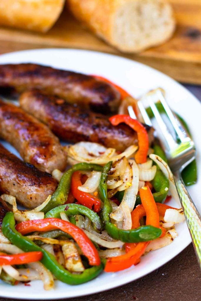 This classic combination of Grilled Sausage, Peppers and Onions is totally easy to make and delicious. Made with mild Italian sausage, sliced red and green bell pepper and yellow onions seasoned with salt and pepper and cooked on the grill.