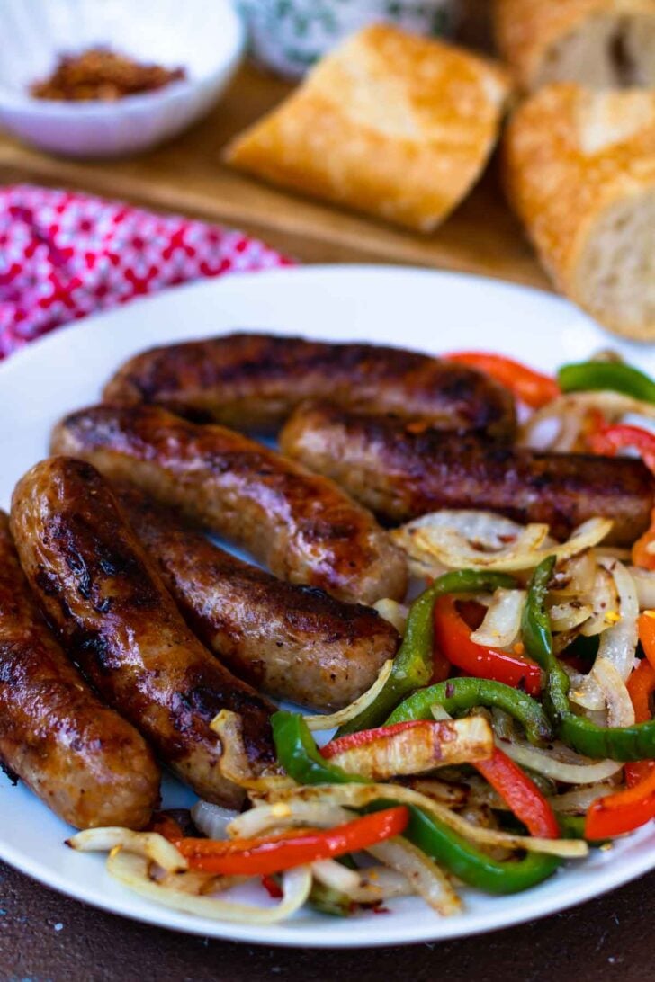 This classic combination of Grilled Sausage, Peppers and Onions is totally easy to make and delicious. Made with mild Italian sausage, sliced red and green bell pepper and yellow onions seasoned with salt and pepper and cooked on the grill.