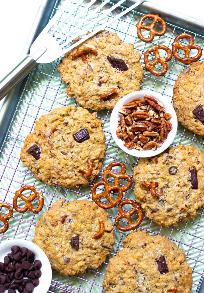 Kitchen Sink Cookies are loaded with sweet, savory and salty goodness! Made with butter, sugar, flour, oats, dark chocolate, chocolate chips, coconut, pecans and pretzels. This is one cookie that that has something for everyone!