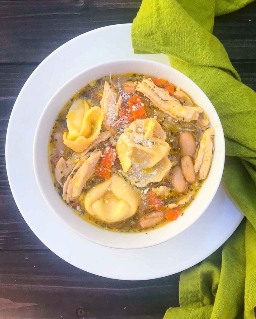 Homemade Chicken and Cheese Tortellini Soup is hearty and so easy to make. Made with rotesseri chicken, cheese filled tortellini, white beans, carrots, celery and herbs in a store bought broth.