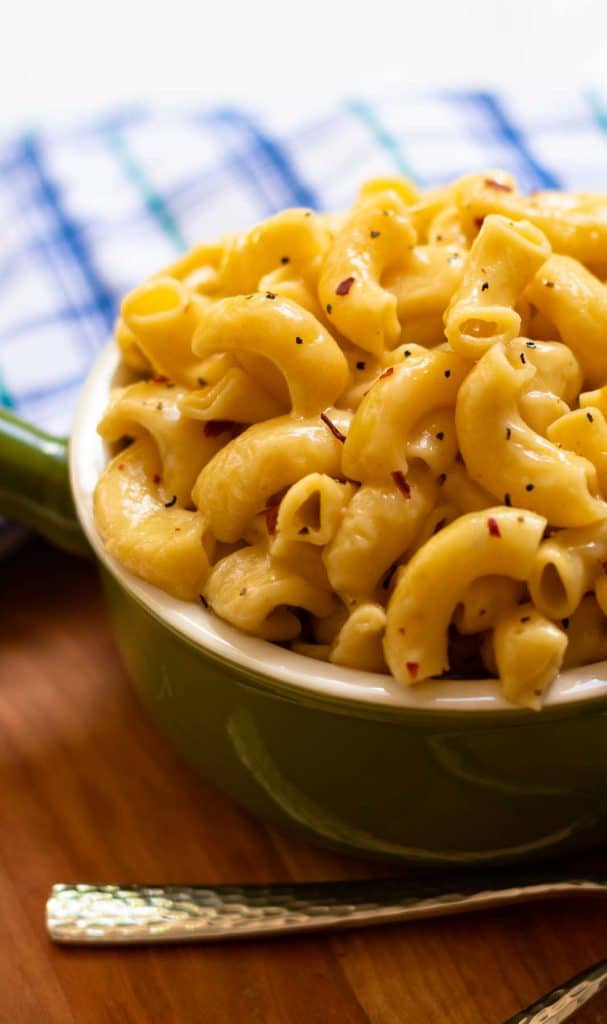 Instant Pot Mac and Cheese with red and black pepper flakes.