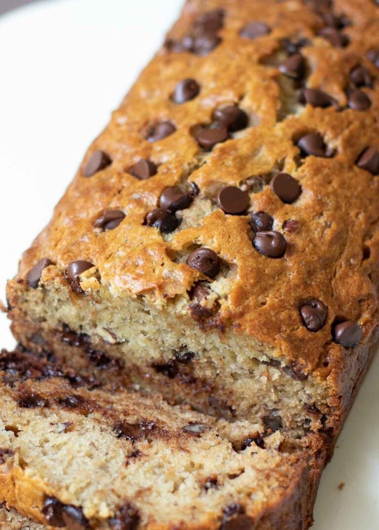 Chocolate Chip Banana Bread with golden brown top sliced for serving.