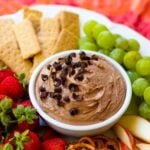 Chocolate Dip in bowl on fruit platter with cookies and pretzels.