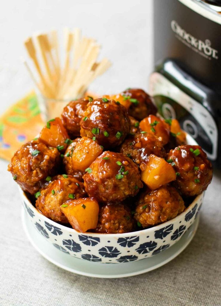Crock Pot Hawaiian Meatballs smothered in a sweet tangy sauce with pineapple and fresh ginger are cooked low and slow making them tender and juicy. These succulent meatballs are a slow cooker masterpiece and are great served as an appetizer or main dish!