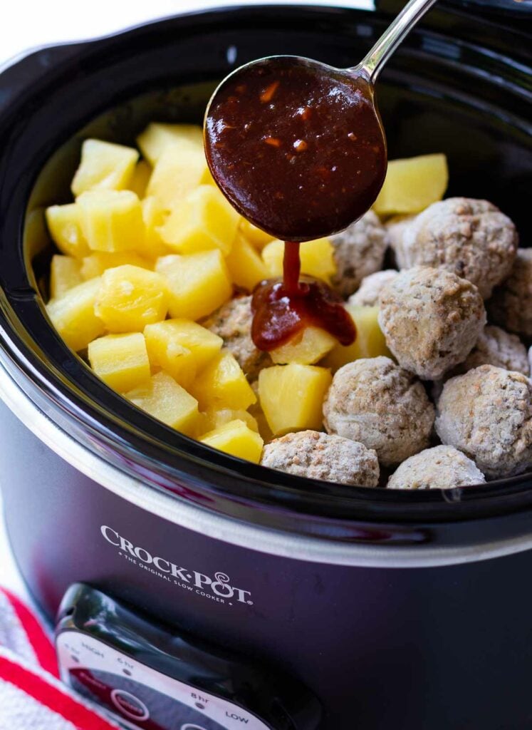 Crock Pot Hawaiian Meatballs with sauce poured from spoon.