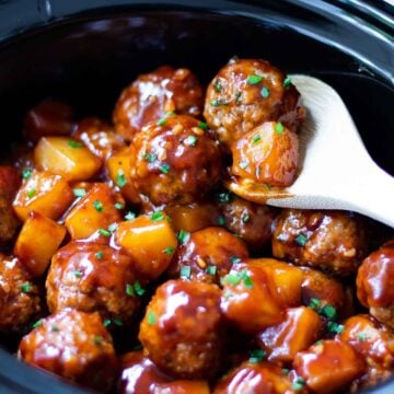 Crock Pot Hawaiian Meatballs on spoon with pineapple.