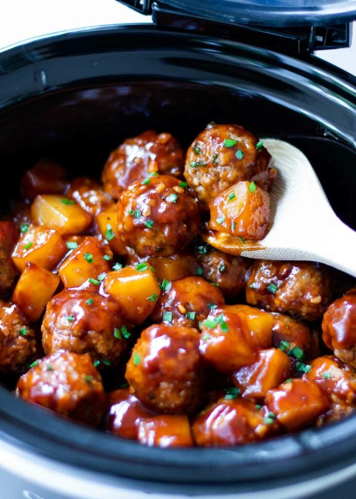 Crock Pot Hawaiian Meatballs on spoon with pineapple.