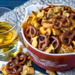 Spicy Cheese Crackers with pretzels and Fritos with a drink for snack time.