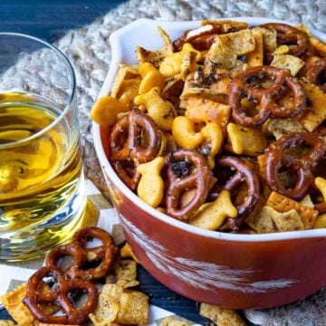 Spicy Cheese Crackers with pretzels and Fritos with a drink for snack time.