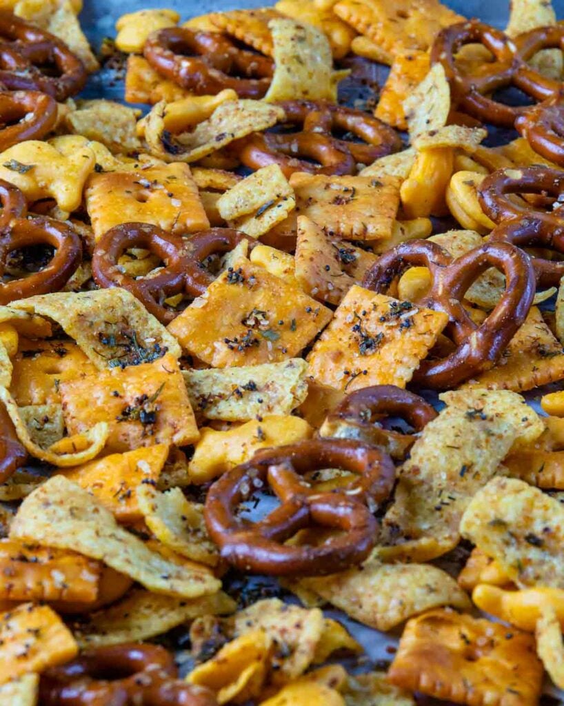 Spicy Cheese Cracker Snack Mix with pretzels on a sheet pan.