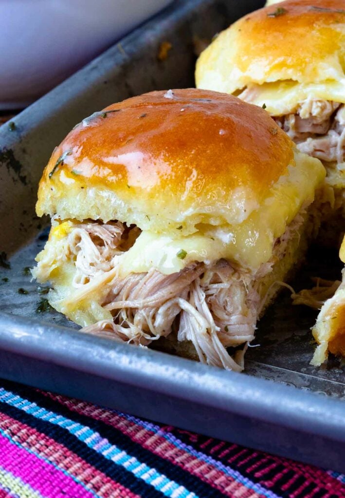 Toasted bun loaded with Crock Pot Mississippi Chicken and cheese.