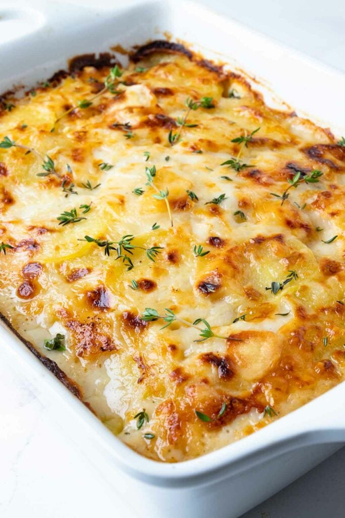 Beautifully golden and perfectly cooked Scalloped Potatoes in a casserole dish.