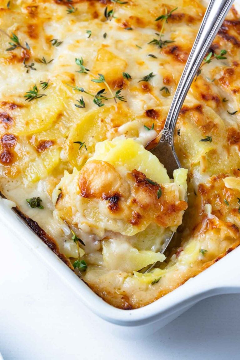 Beautifully golden and perfectly cooked Scalloped Potatoes in a casserole dish.